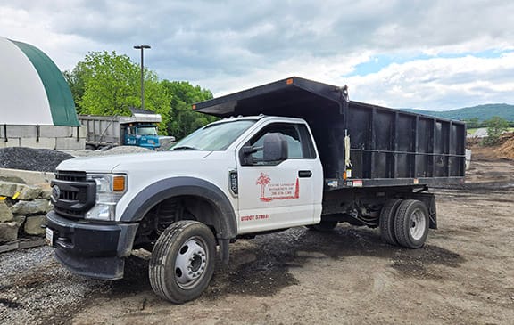 Custom Landscape Management's dump truck with logo on the side